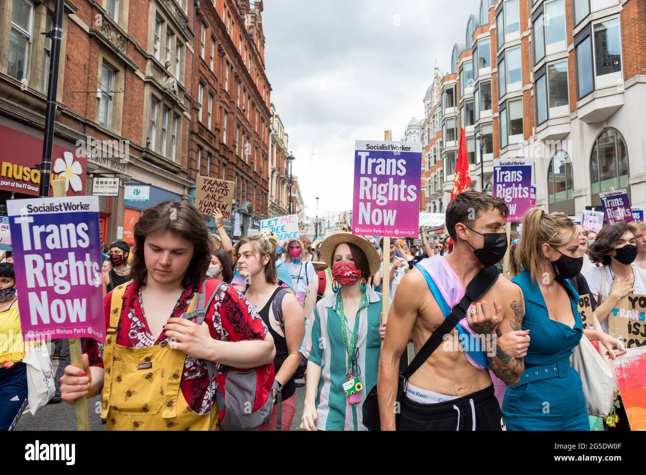 London, UK. 26th June, 2021. Protestors seen along Soho with placards expressing their opinion, during the march.The Transgender Pride rally were coordinated by Socialist Workers, calling for protection of the rights of transgender people in the UK. The march took place in Leicester Square. Credit: SOPA Images Limited/Alamy Live News Stock Photo