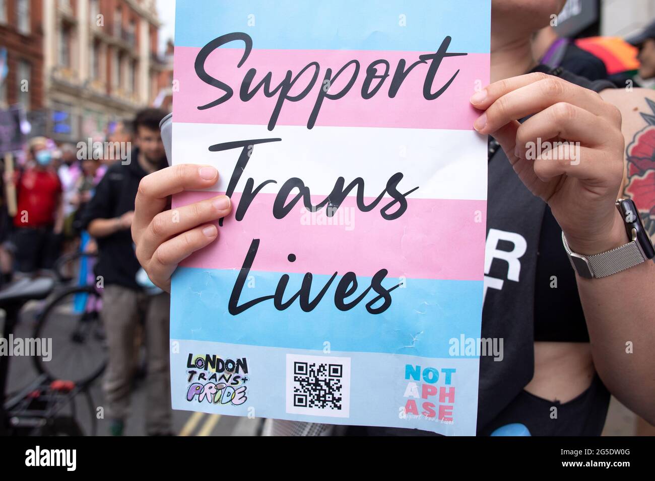 London, UK. 26th June, 2021. A placard that says 'support trans lives' printed against the transgender pride flag during the march.The Transgender Pride rally were coordinated by Socialist Workers, calling for protection of the rights of transgender people in the UK. The march took place in Leicester Square. Credit: SOPA Images Limited/Alamy Live News Stock Photo