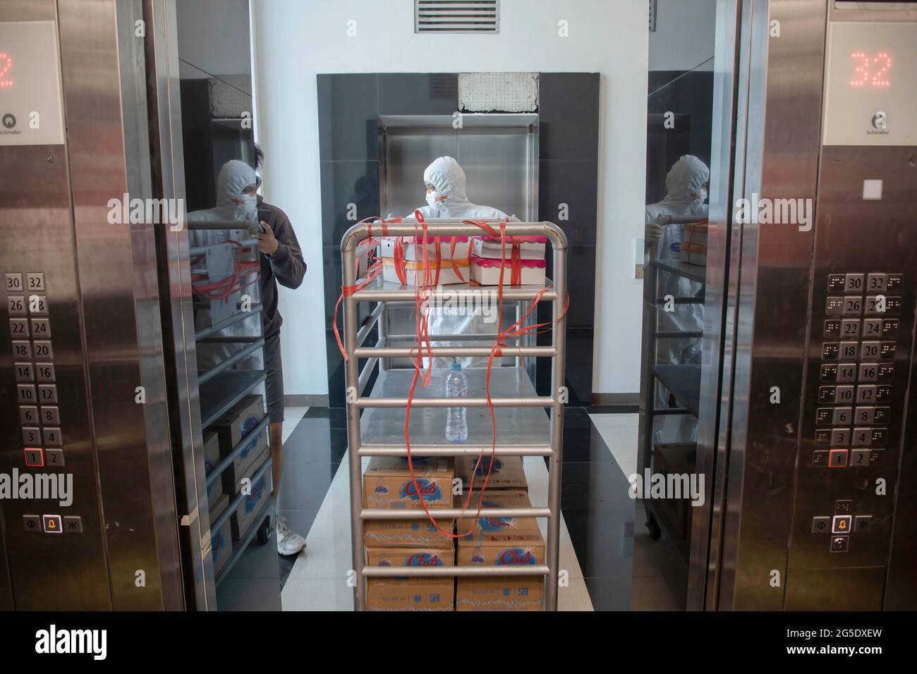 Jakarta, Indonesia. 26th June, 2021. Health workers wearing Personal Protective Equipment are seen inside the Wisma Atlet Covid-19 Emergency Hospital complex. Indonesia has experienced a significant spike in COVID-19 cases by recording 21,350 cases today (26/6/2021), putting pressure on hospitals, including in the capital city, where most of hospital beds are full. Credit: SOPA Images Limited/Alamy Live News Stock Photo