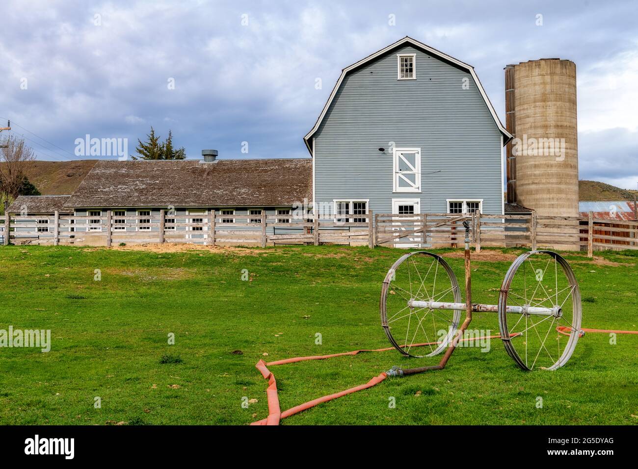 Idaho farm with barn and watering system in a pasture. Stock Photo