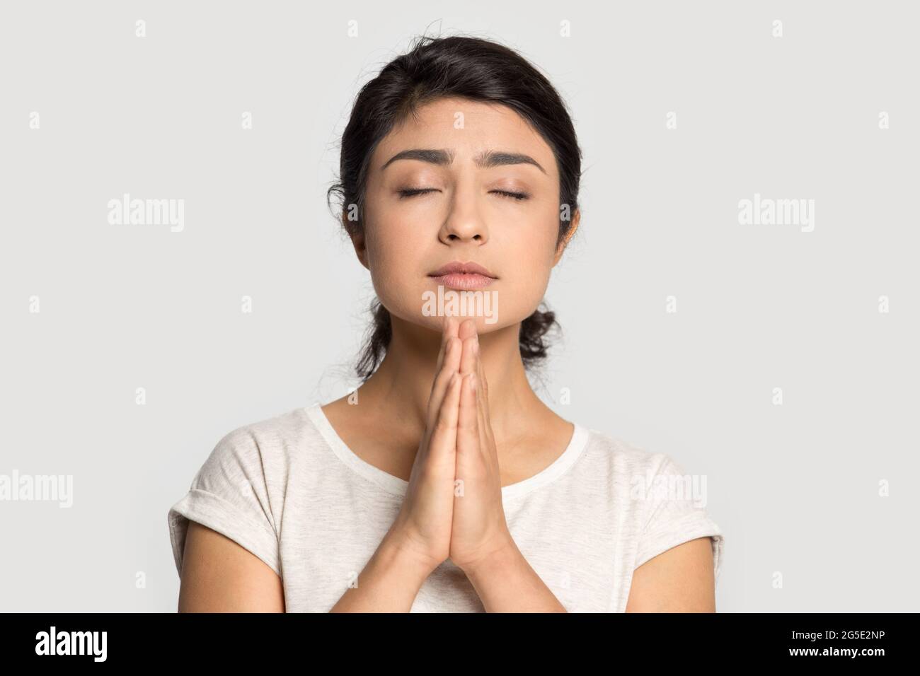 Hopeful Indian woman pray ask feeling superstitious Stock Photo