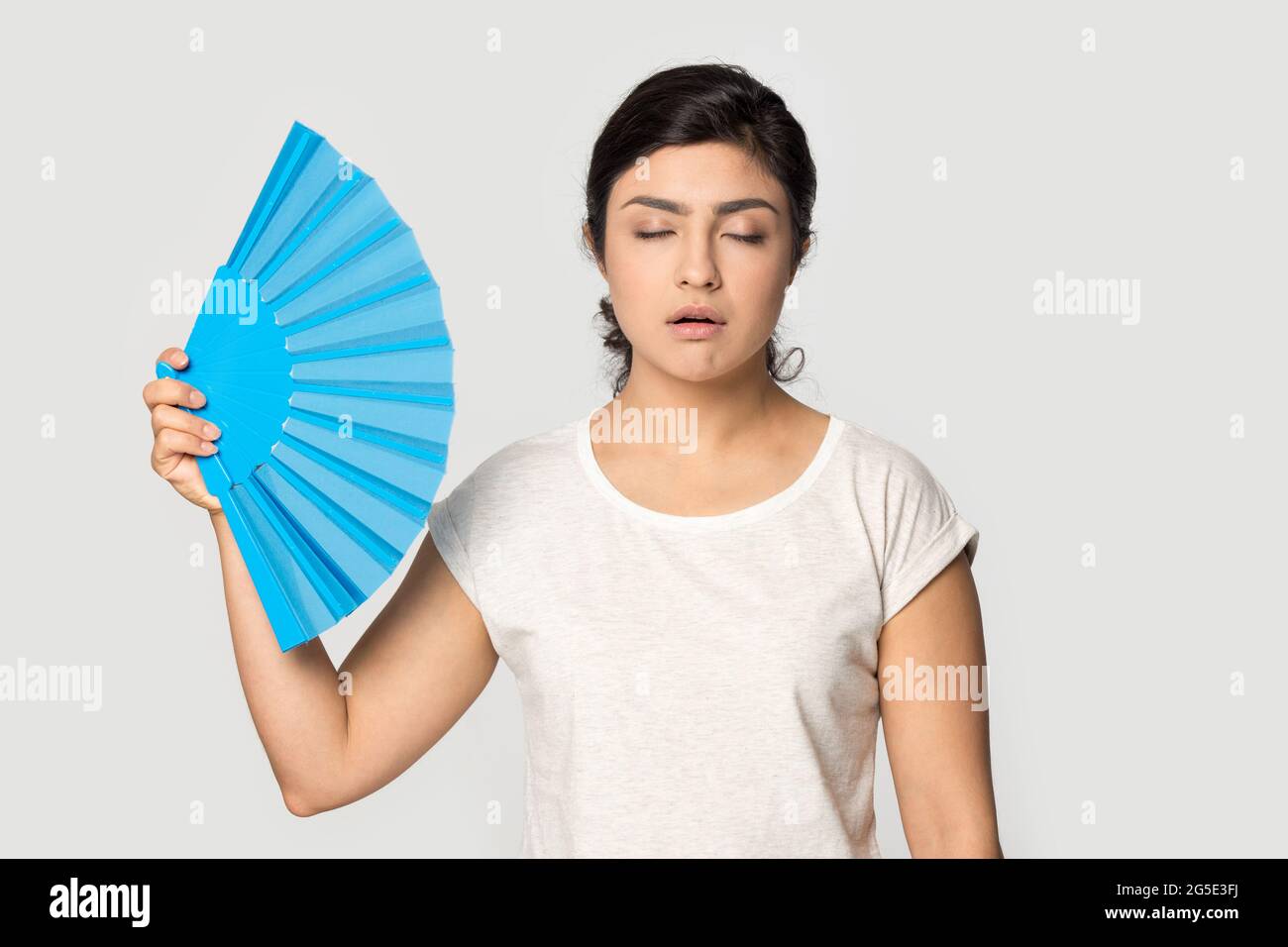Unwell Indian woman use hand fan breathe fresh air Stock Photo Alamy