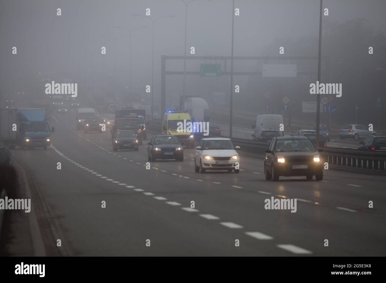 Driving a car in bad weather conditions, foggy day on the road Stock Photo