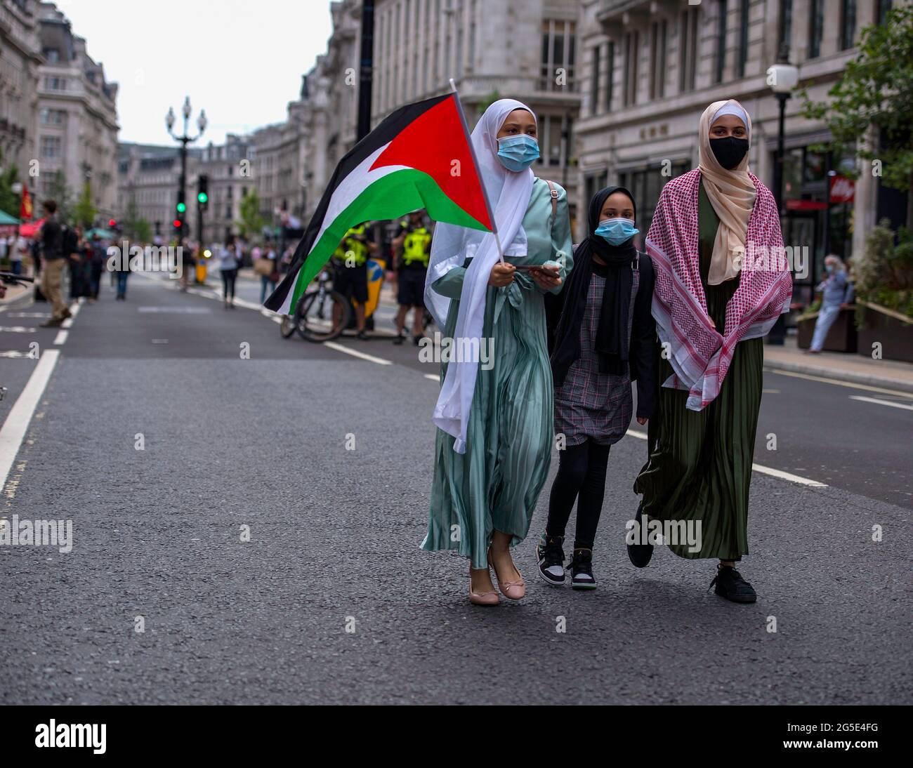 London, UK. 26th June, 2021. An activist hold a Palestinian flag during the demonstration/ People's Assembly held a National Protest in London demonstrating a plethora of issues from the Palestine and Israel conflict, coronavirus issues and the government handling of the pandemic, the police crime bill, and anti-arms matters. (Photo by Loredana Sangiuliano/SOPA Imag/Sipa USA) Credit: Sipa USA/Alamy Live News Stock Photo