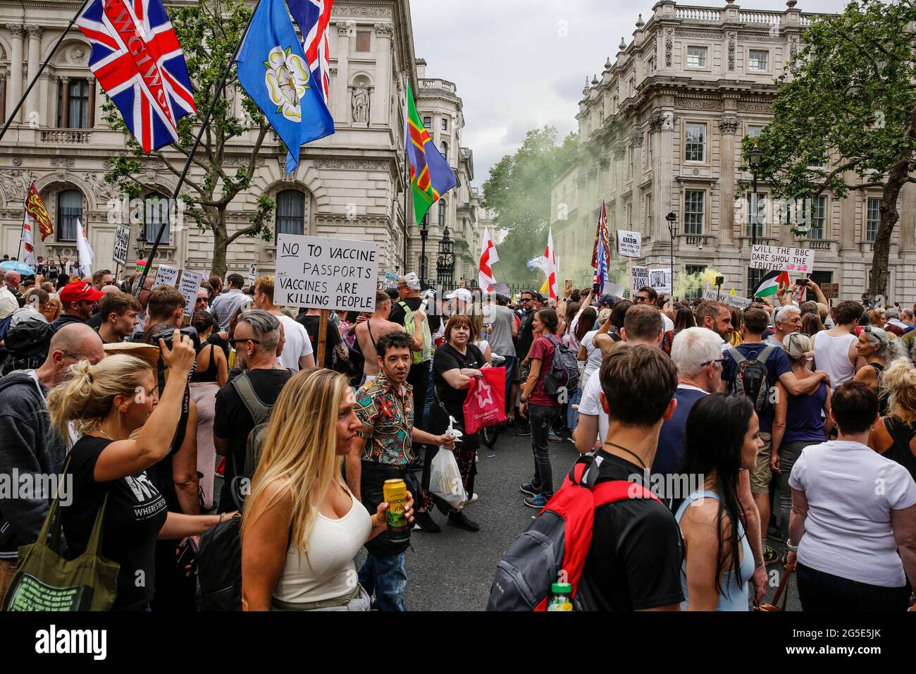 London, UK on June 26, 2021: Protesters holding placards demonstrate in front of Downing Street during Anti-Lockdown demonstration Unite for Freedom. People protesting against the lockdowns came together to raise their concerns regarding government vaccination legislations and freedom to travel and socialize. Stock Photo