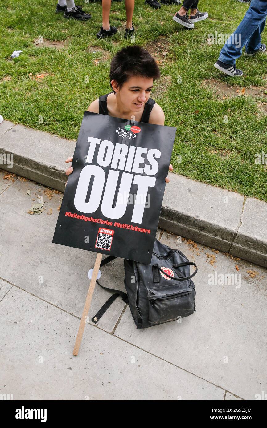 London,  UK on June 26, 2021: Anti-government activists  protest in front of the Westminster at Parliament Square. The protest unites activists from many opposition left wing movements such as Kill the Bill, The People's Assembly, NHS Staff Voices, Stop the War Coalition or Extintion Rebellion. Stock Photo