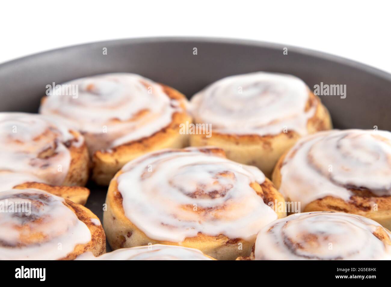 Fresh Cinnamon Rolls with White Icing in a Baking Pan Stock Photo