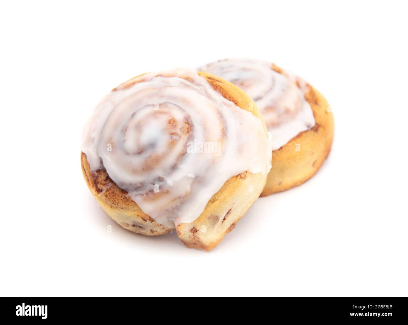 Two Frosted Cinnamon Rolls on a White Background Stock Photo