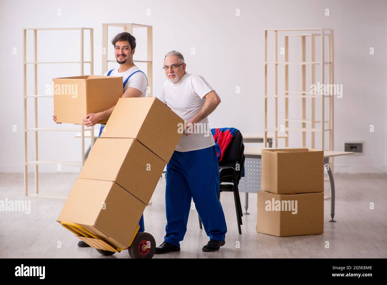 Two professional movers doing home relocation Stock Photo