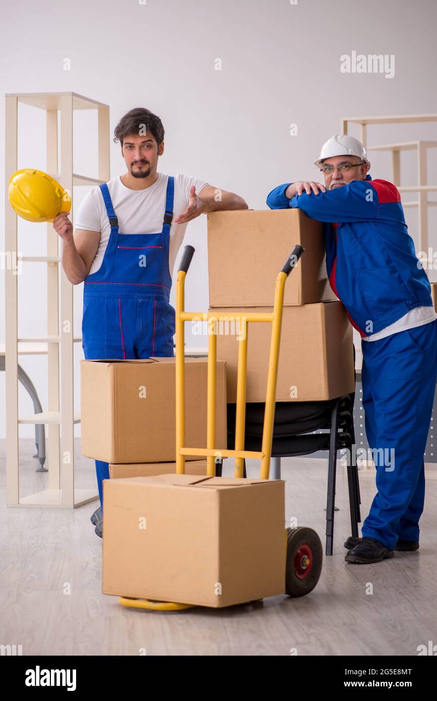 Two professional movers doing home relocation Stock Photo