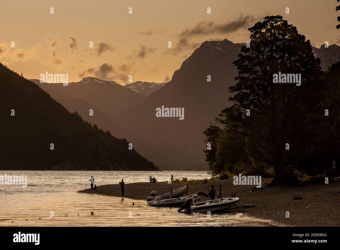 People fishing at the afternoon in Futalaufquen Lake, located in the Los Alerces National Park, Patagonia Argentina. Stock Photo