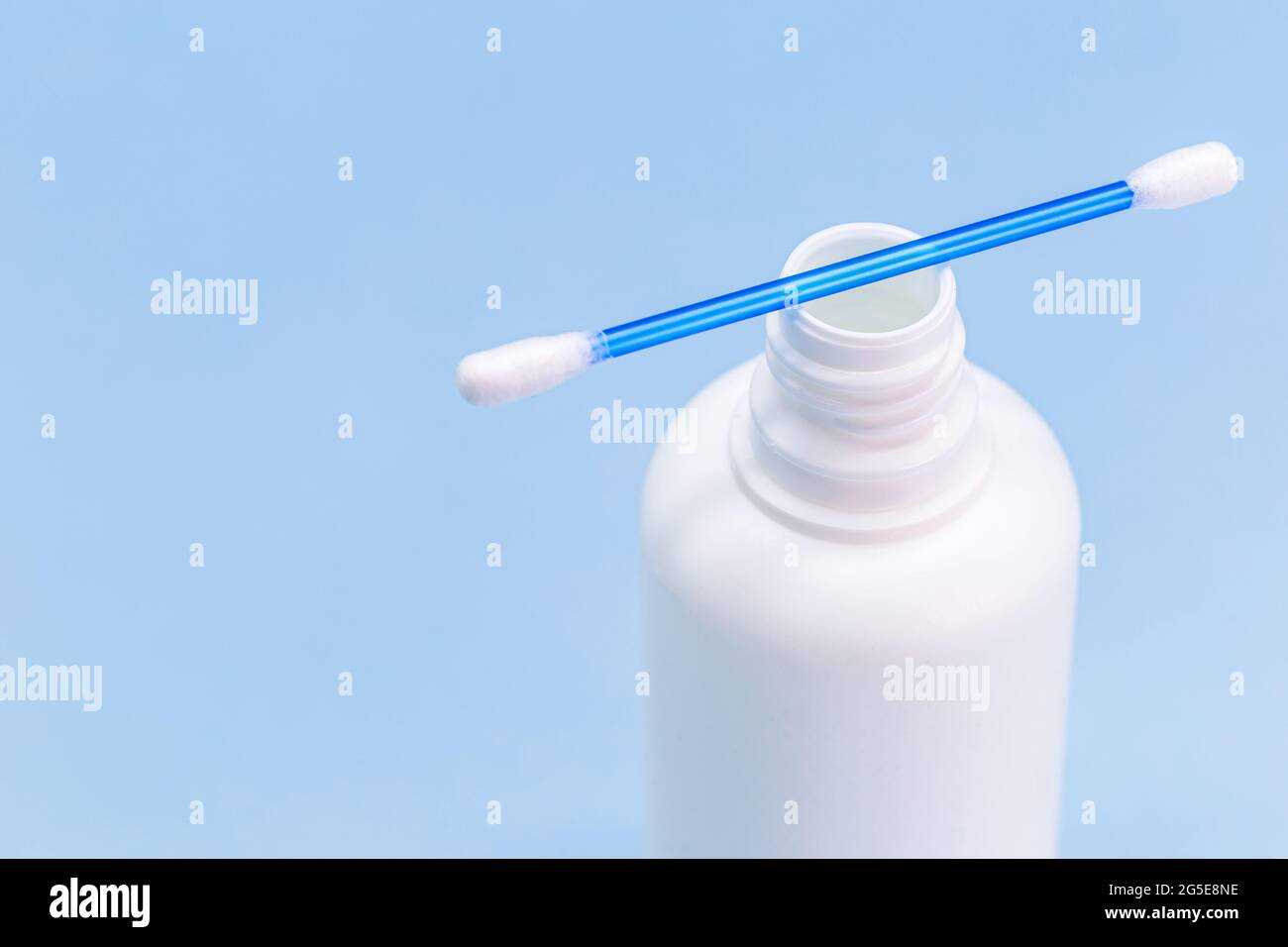 hydrogen peroxide, in white plastic bottle, with cotton swab and