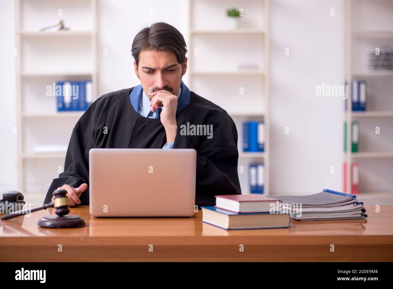 Young judge working in the courtroom Stock Photo - Alamy