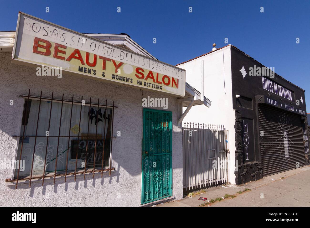 Local run down beauty salon next to a new hipster business in