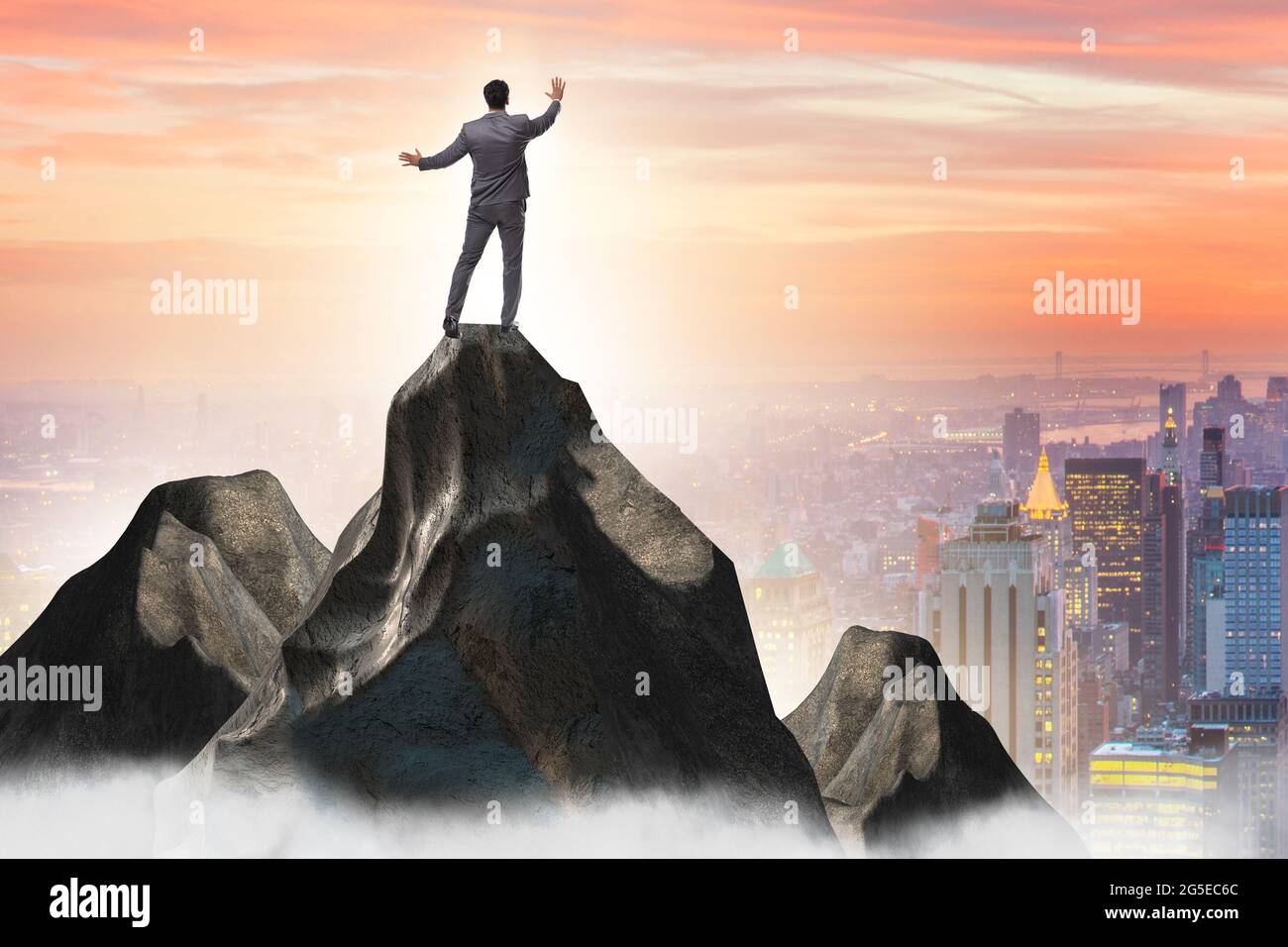 Businessman at the top of mountain in the career concept Stock Photo ...