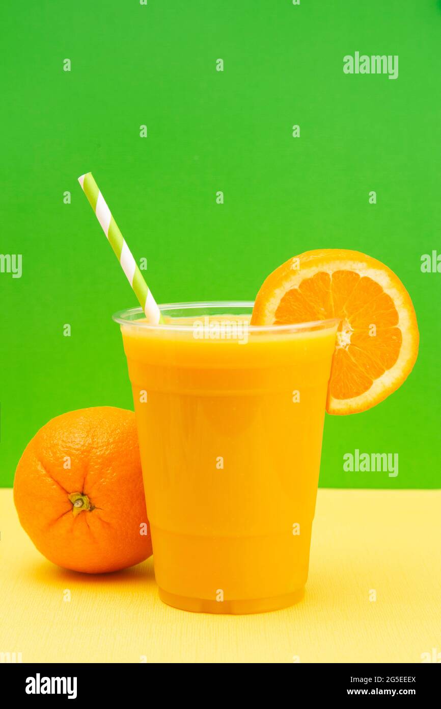 Freshly Squeezed Orange Juice in a Plastic Disposable Cup Stock Photo
