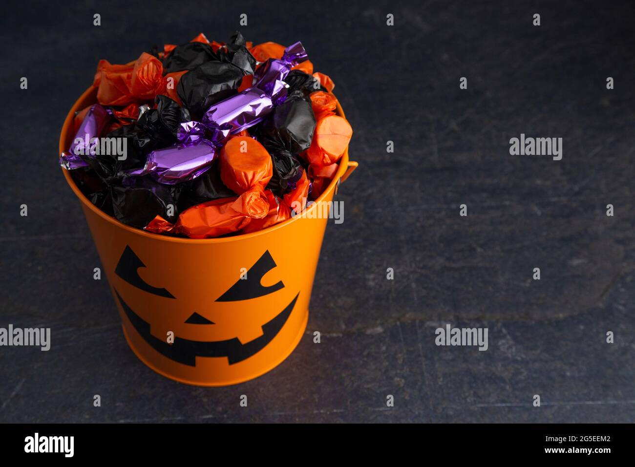 Pumpkin Bucket Filled with Various Wrapped Candies Stock Photo Alamy