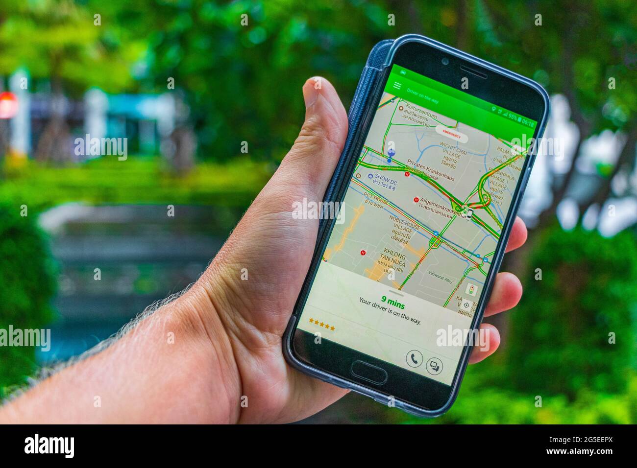 Taxi Grab app on the phone screen in the hand in Bangkok Thailand 