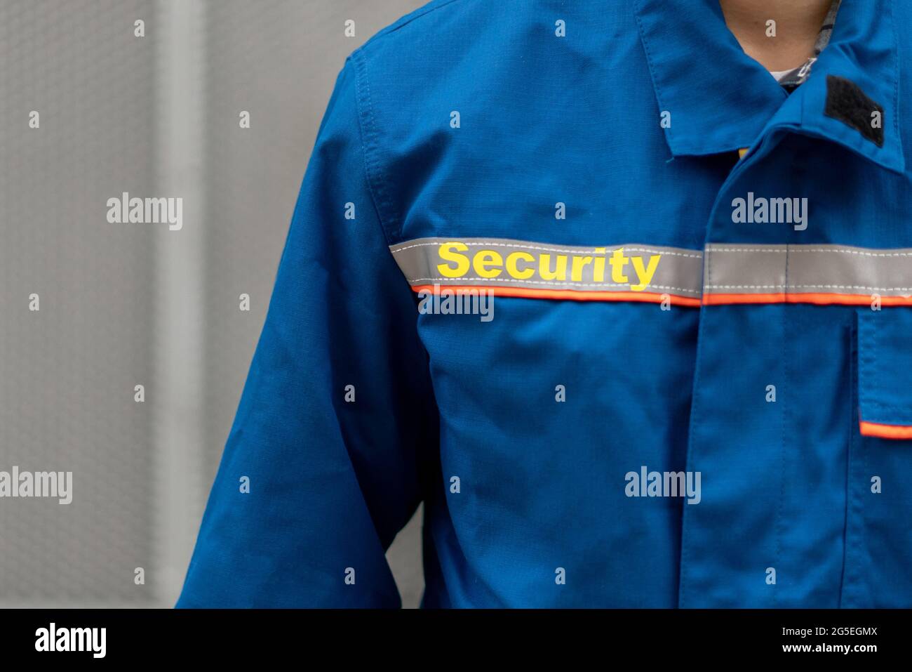 close up man person in uniform with word "security guard" on it Stock