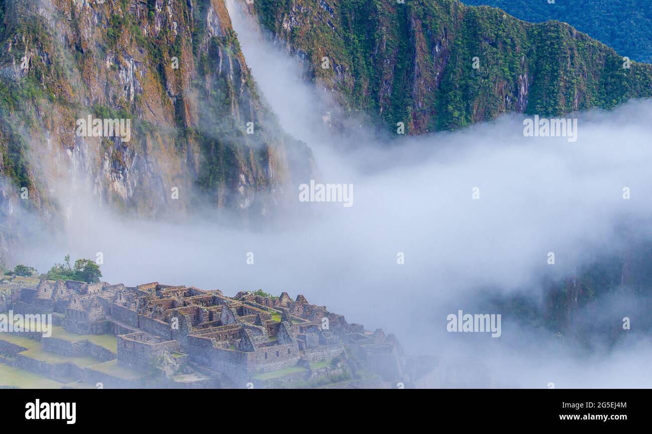 Clouds over Machu Picchu ruins Stock Photo - Alamy