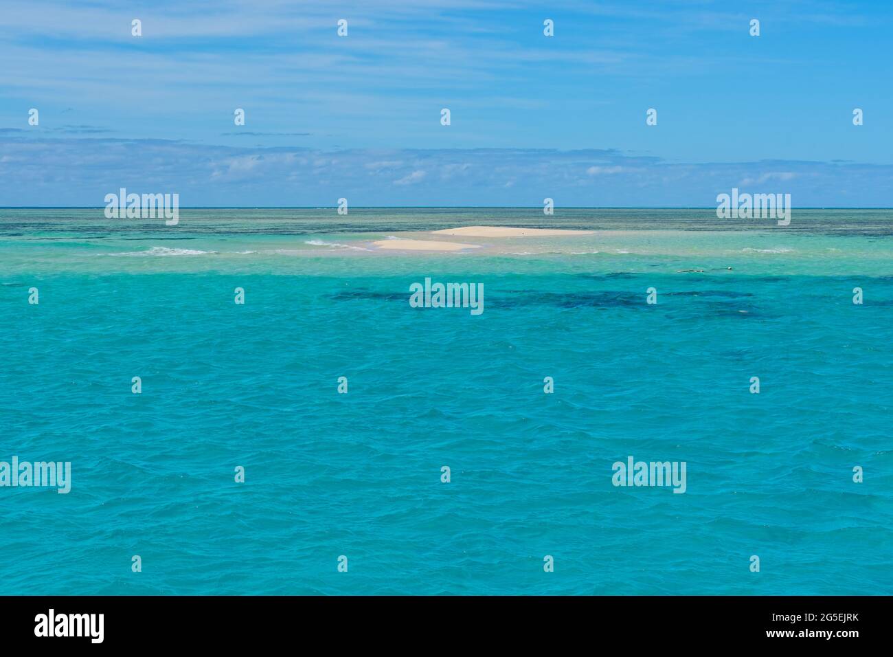 Sand cay in the Great Barrier Reef surrounded by crystal clear water