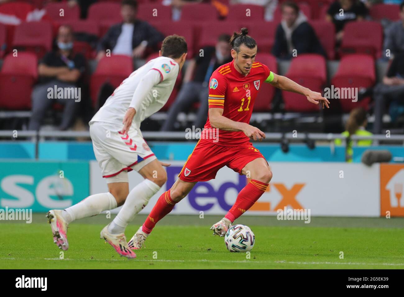 Amsterdam, Netherlands. 26th June, 2021. Gareth Bale (R) of Wales dribbles during the UEFA Euro 2020 Championship Round of 16 match between Wales and Denmark at Johan Cruijff ArenA in Amsterdam, the Netherlands, June 26, 2021. Credit: Zheng Huansong/Xinhua/Alamy Live News Stock Photo