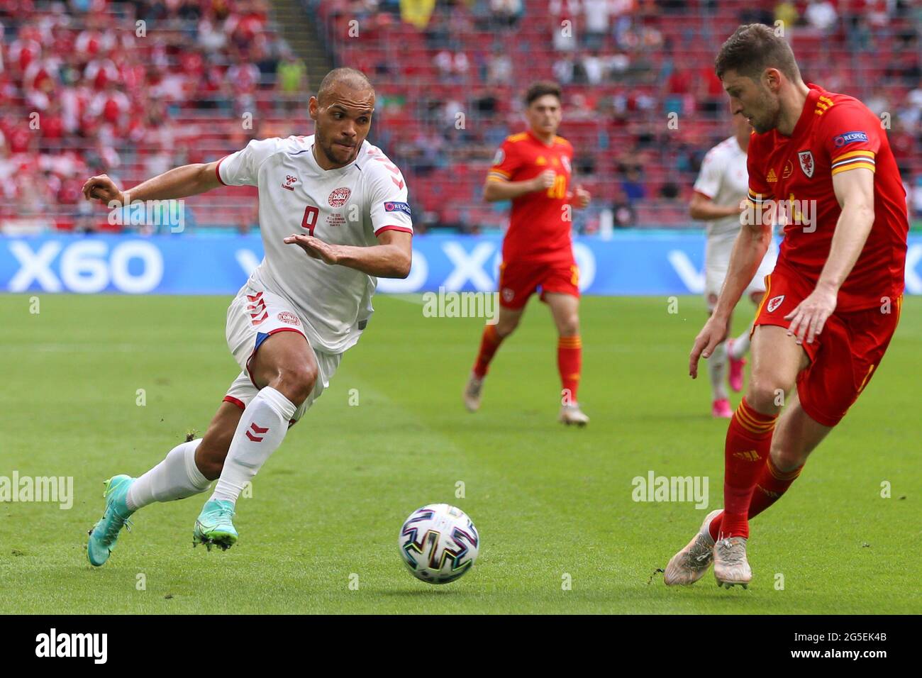 Amsterdam, Netherlands. 26th June, 2021. Martin Braithwaite (L) of Denmark dribbles during the UEFA Euro 2020 Championship Round of 16 match between Wales and Denmark at Johan Cruijff ArenA in Amsterdam, the Netherlands, June 26, 2021. Credit: Zheng Huansong/Xinhua/Alamy Live News Stock Photo