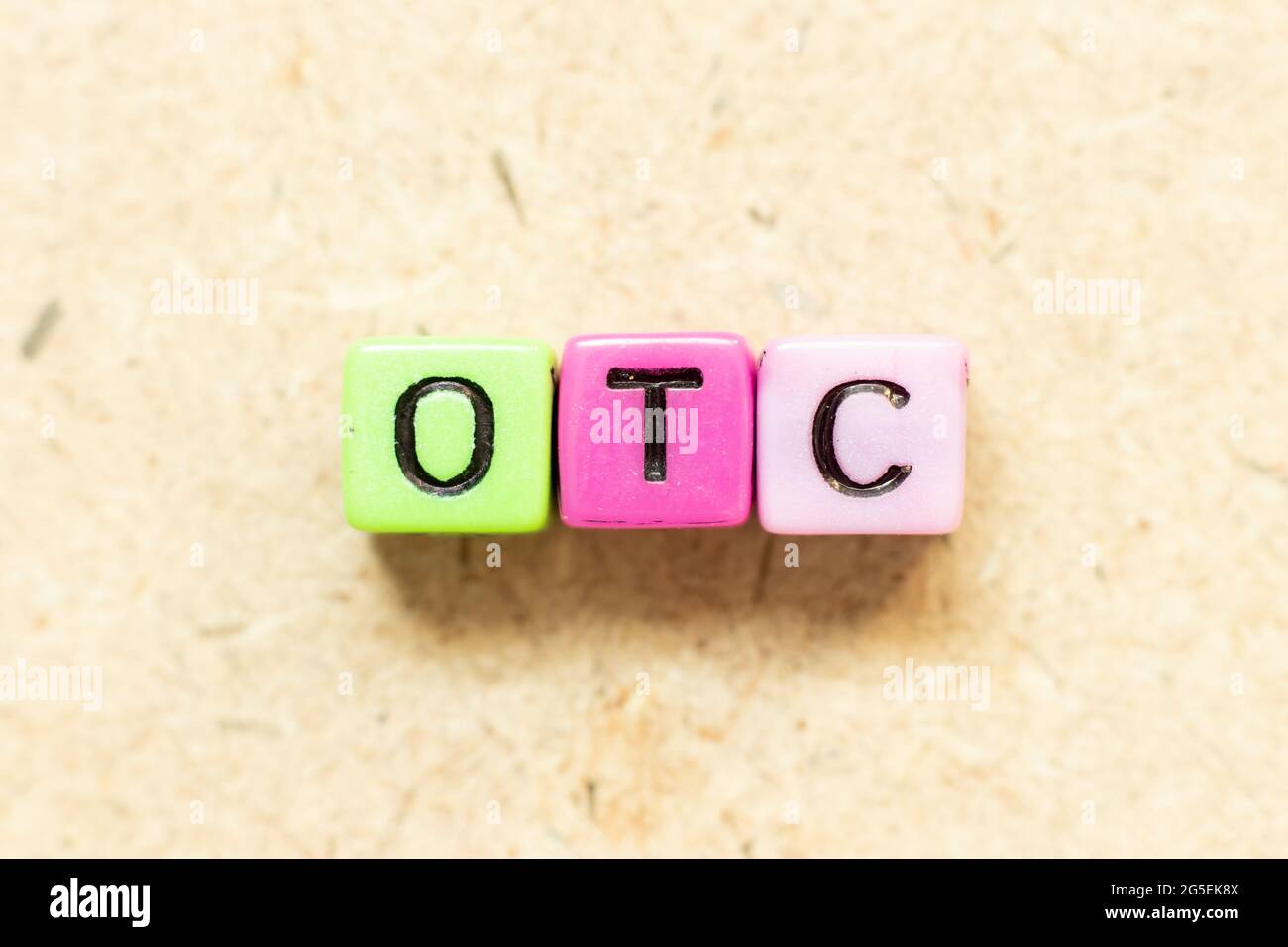 Color alphabet letter block in word OTC (Abbreviation of over the counter) on wood background Stock Photo
