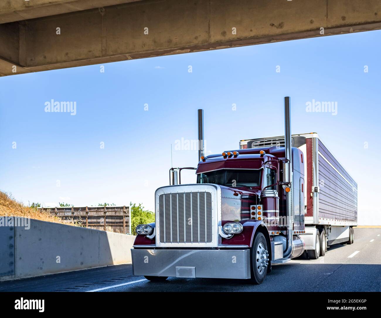 Red industrial long haul Big rig bonnet semi truck with chrome transporting  frozen commercial cargo in refrigerator semi trailer running for delivery  Stock Photo - Alamy