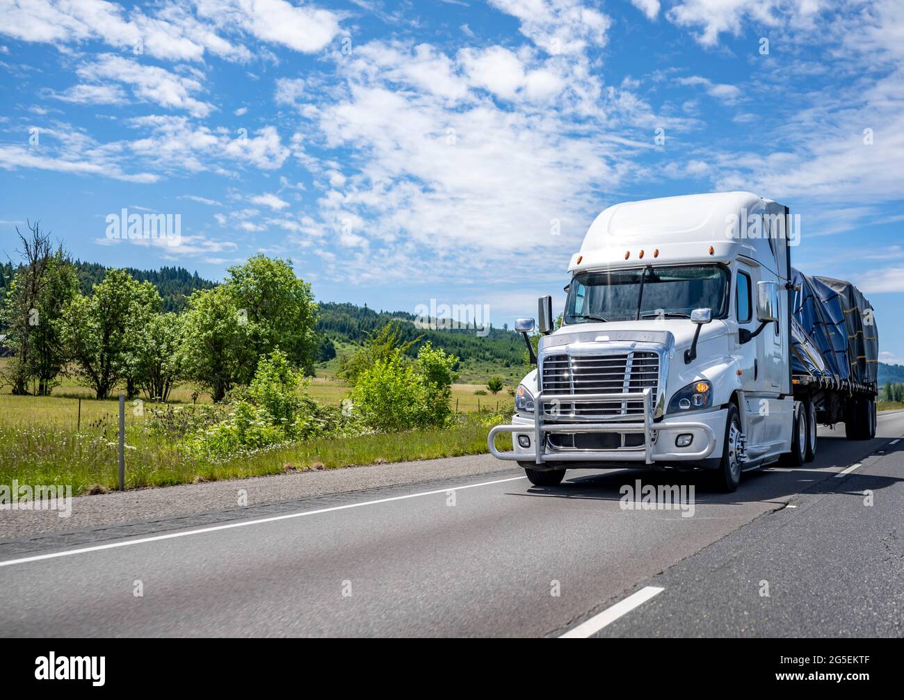 White big rig American semi truck with high cab for comfortable long