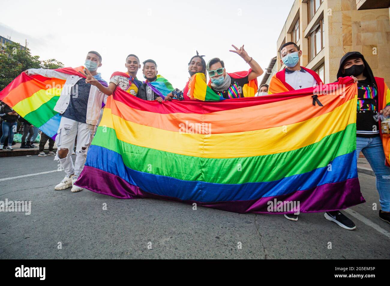 Demonstrators hold the LGTBQ flag during the annual celebreation of the Pride Parade in demand of LGTBQ rights in Colombia in Pasto, Narino - Colombia on June 25, 2021. Stock Photo