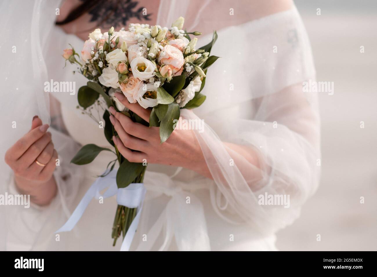 a bouquet of wedding flowers in the bride's hand. close-up Stock Photo -  Alamy