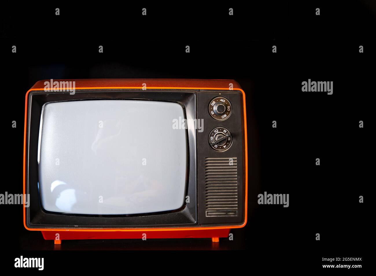 Old vintage red TV on dark background copy space. Stock Photo