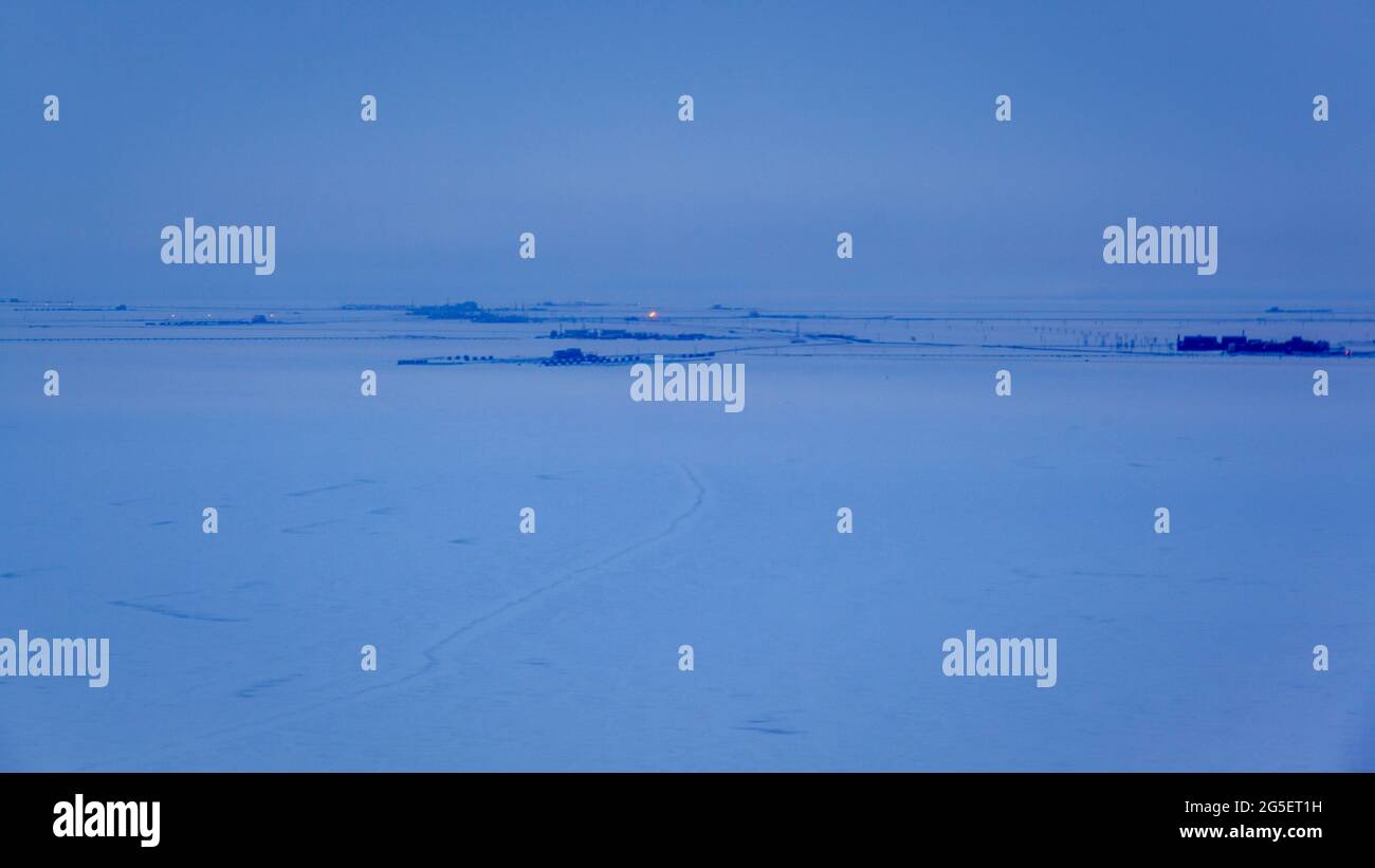 Oil pipeline and iceroad leading from the ConocoPhillips oilwells in Alpine, connecting to the Pump station 1 on the Alyeska Pipeline in Prudhoe Bay, the northern start of the Trans-Alaska Pipeline System. Stock Photo