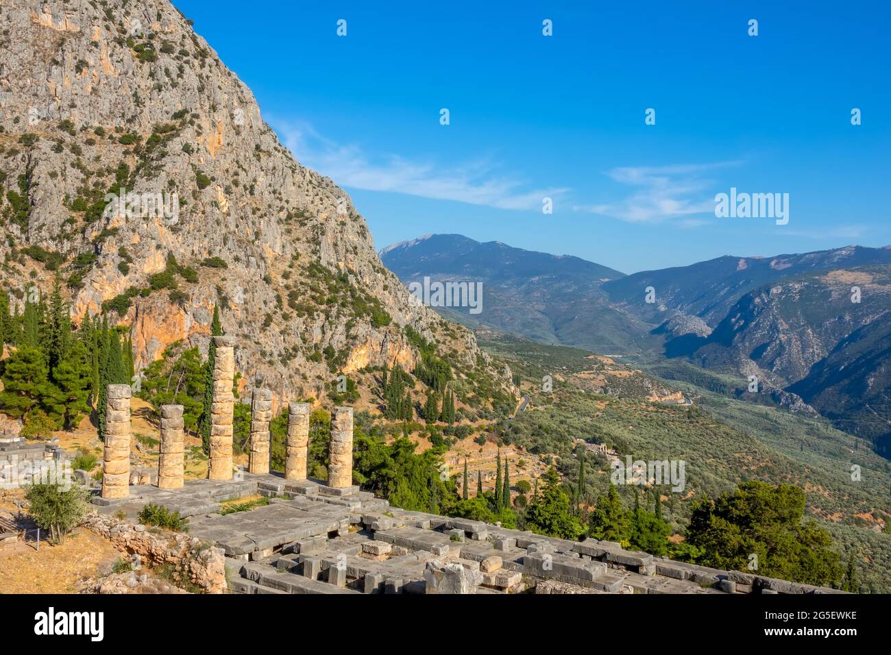 Greece. Delphi. Sunny weather and blue skies over the green valley. Ancient ruins in the mountains Stock Photo