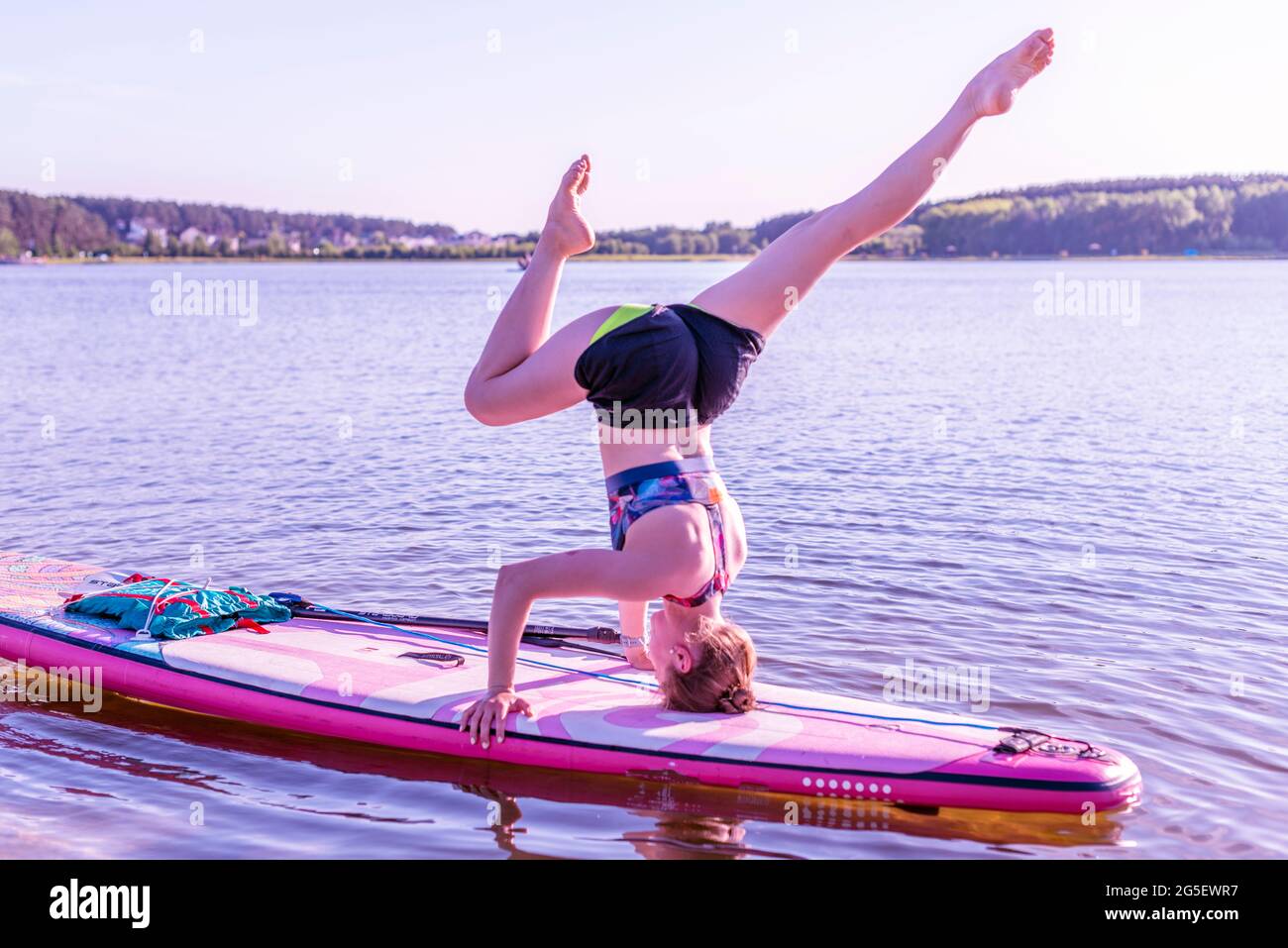 sup board yoga at sunset. outdoor summer activity Stock Photo - Alamy