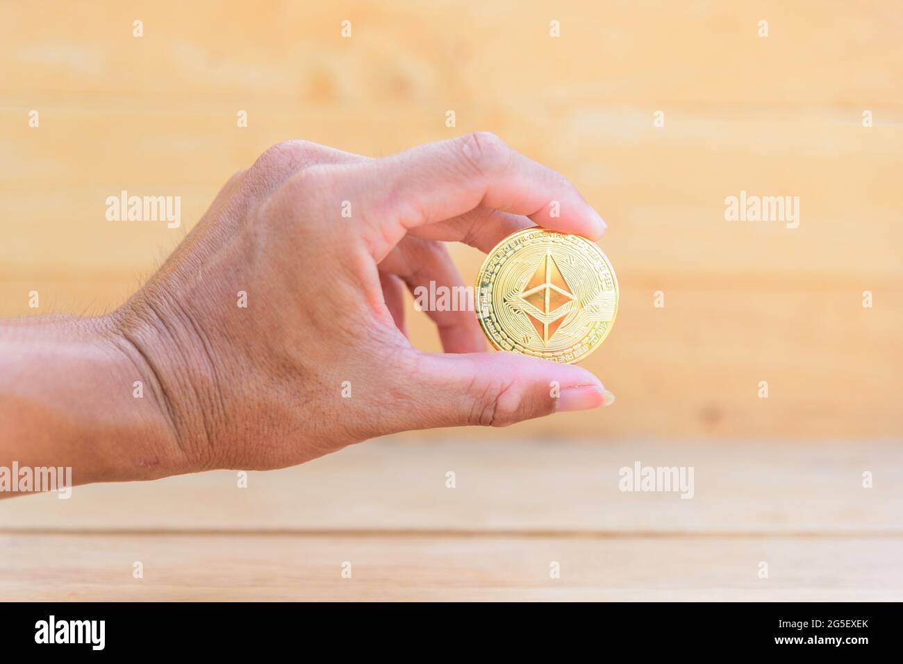 The man show ethereum coin cryptocurrency in his hand Stock Photo