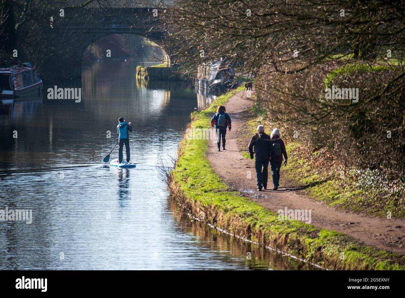 A paddle boarder sailing along the Leeds Liverpool canal Stock Photo