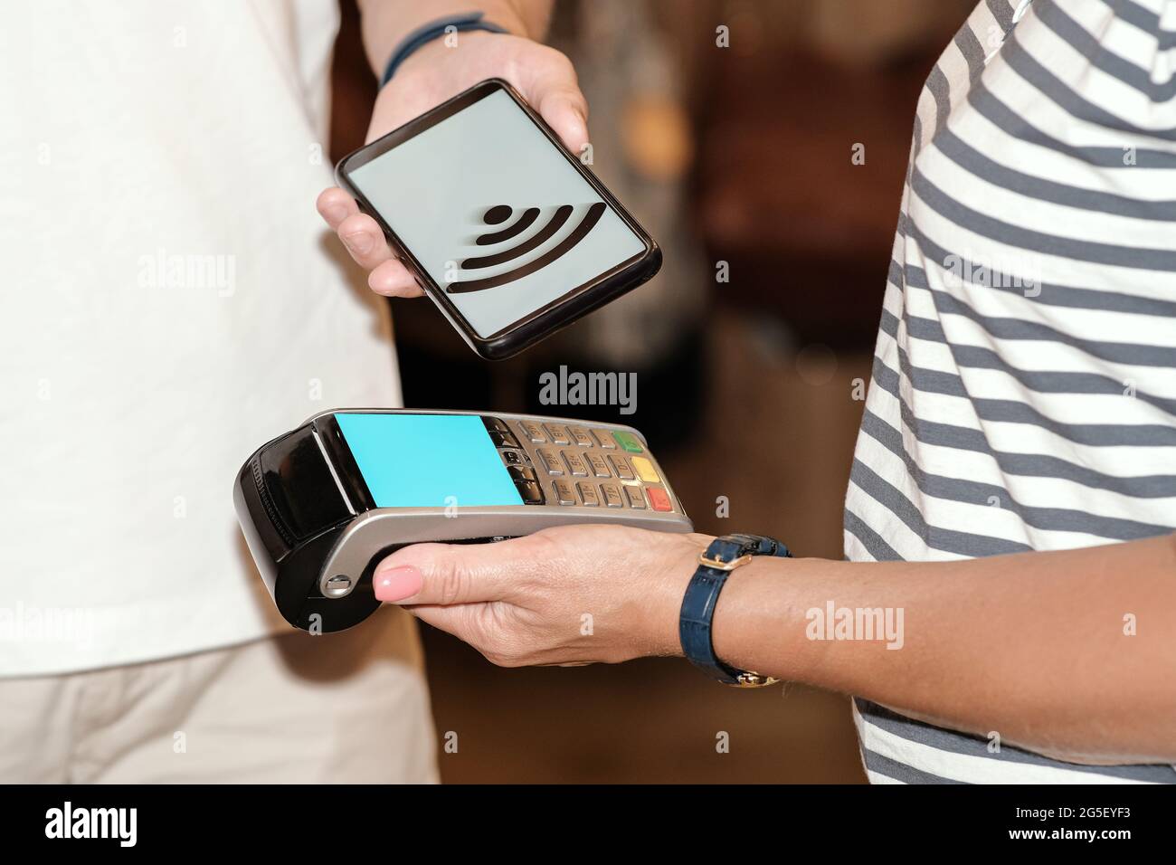 Payment by card, in the payment terminal. Electronic money. Mobile banking. Shopping complex Stock Photo