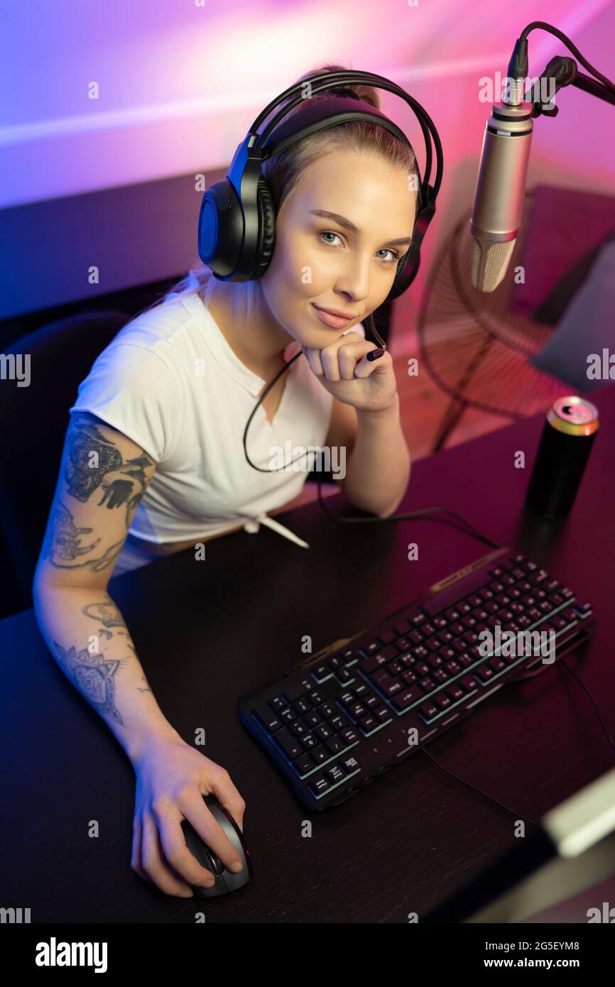 E-sport gamer girl live streaming and plays online video game on PC Stock Photo