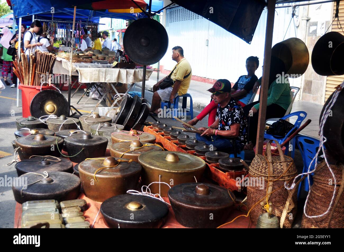Malays playing gongs traditional music instrument malaysian style for show and sale people traveler on street floor shop at Filipino Market Kota Kinab Stock Photo