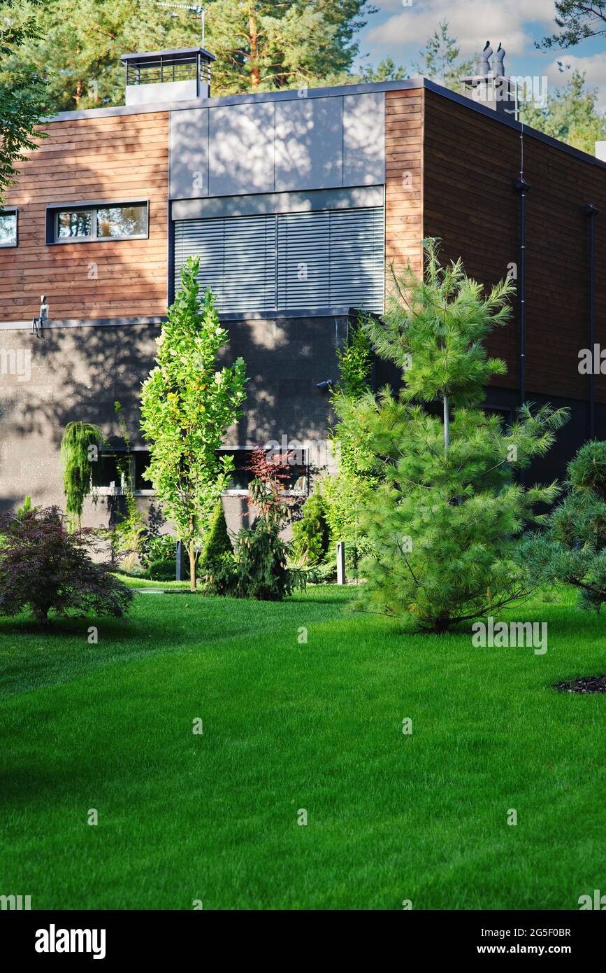 Recreation area. Modern wooden cottage house in pine forest with fresh