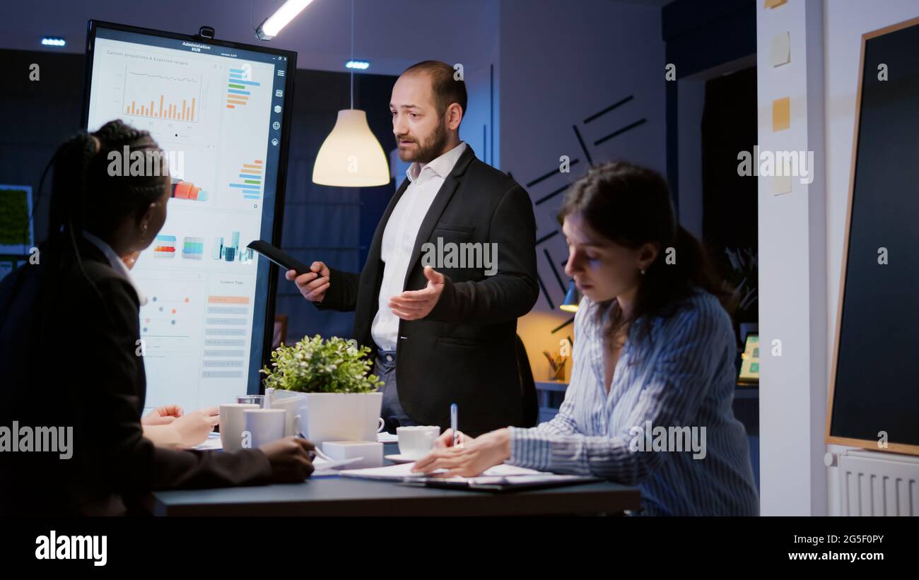 Focused man leader explaining management project using monitor working ...