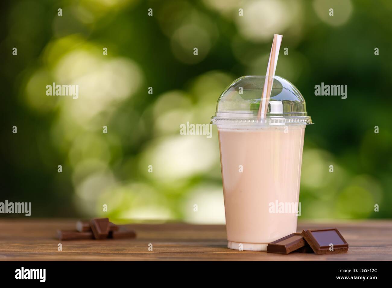 https://c8.alamy.com/comp/2G5F12C/chocolate-milkshake-in-disposable-plastic-glass-on-wooden-table-2G5F12C.jpg