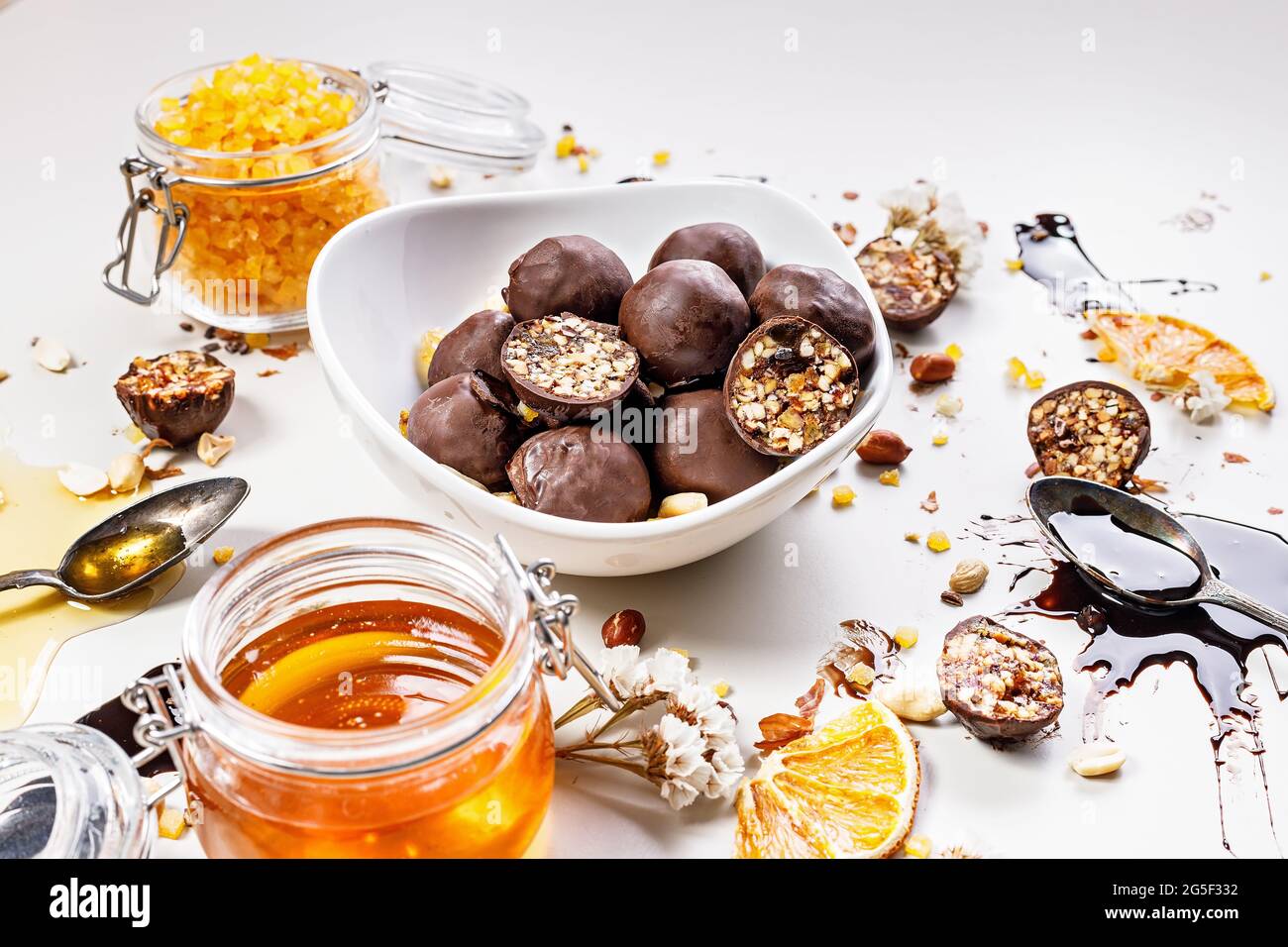 Closeup handmade candy with honey, raisins, candied orange fruits and