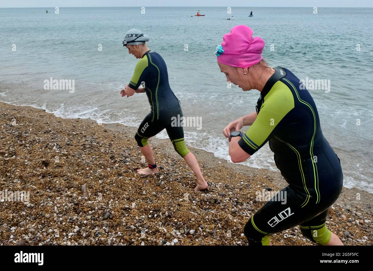 West Bay, Dorset, UK. 27th June, 2021. Winds caused the West Bay Triathlon swim section to be shortened to 400 meters as competitors take part in the West Bay Triathlon on Dorsets Jurassic Coast. Credit: Tom Corban/Alamy Live News Stock Photo