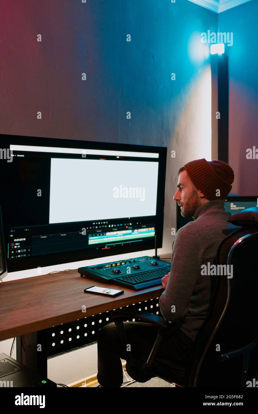 Attractive Male Video Editor Works with Footage or Video on His ...