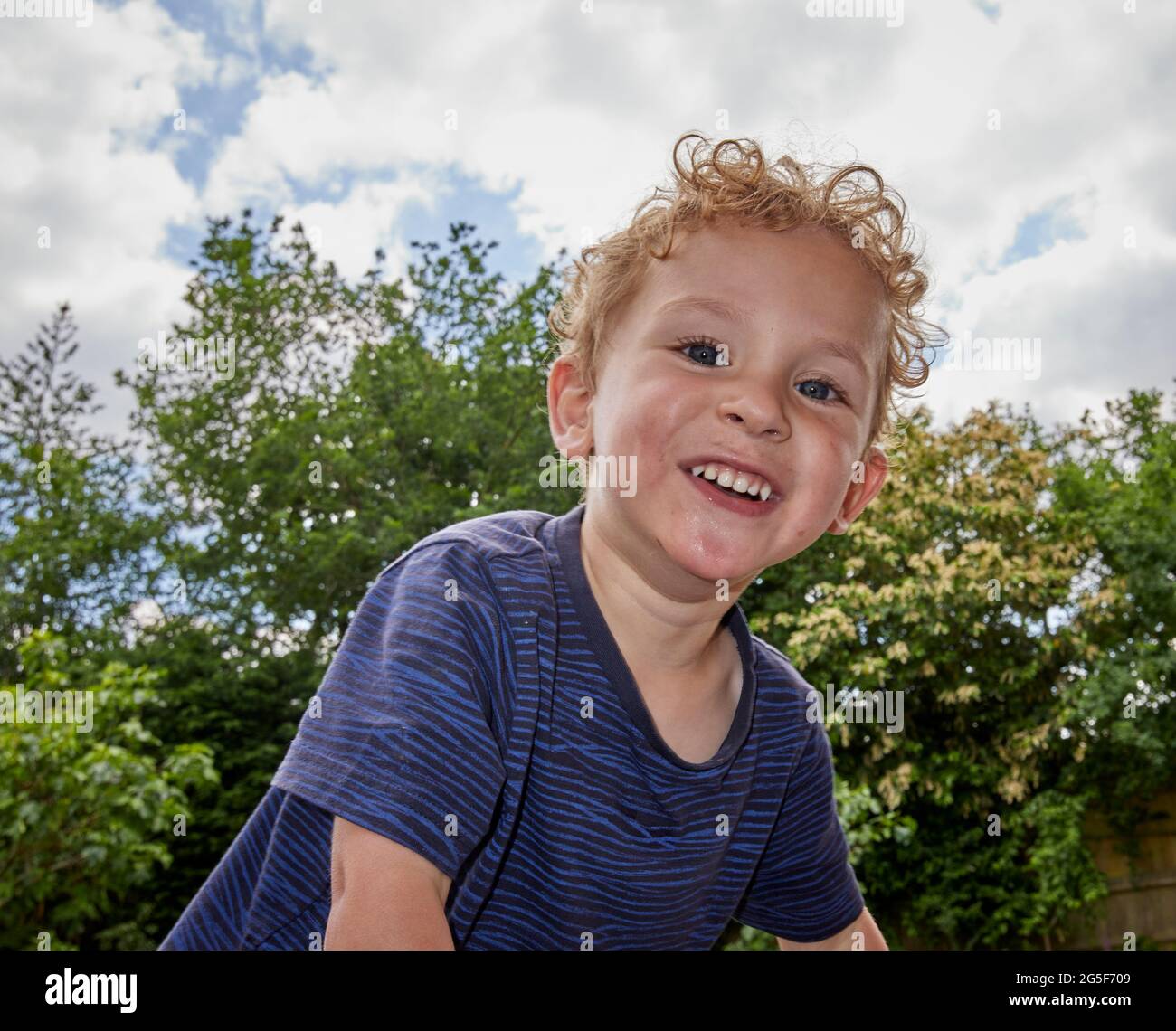 3 year old boy smiling into camera at nursery, holding a cup of milk, Stock  Photo, Picture And Rights Managed Image. Pic. J47-527683