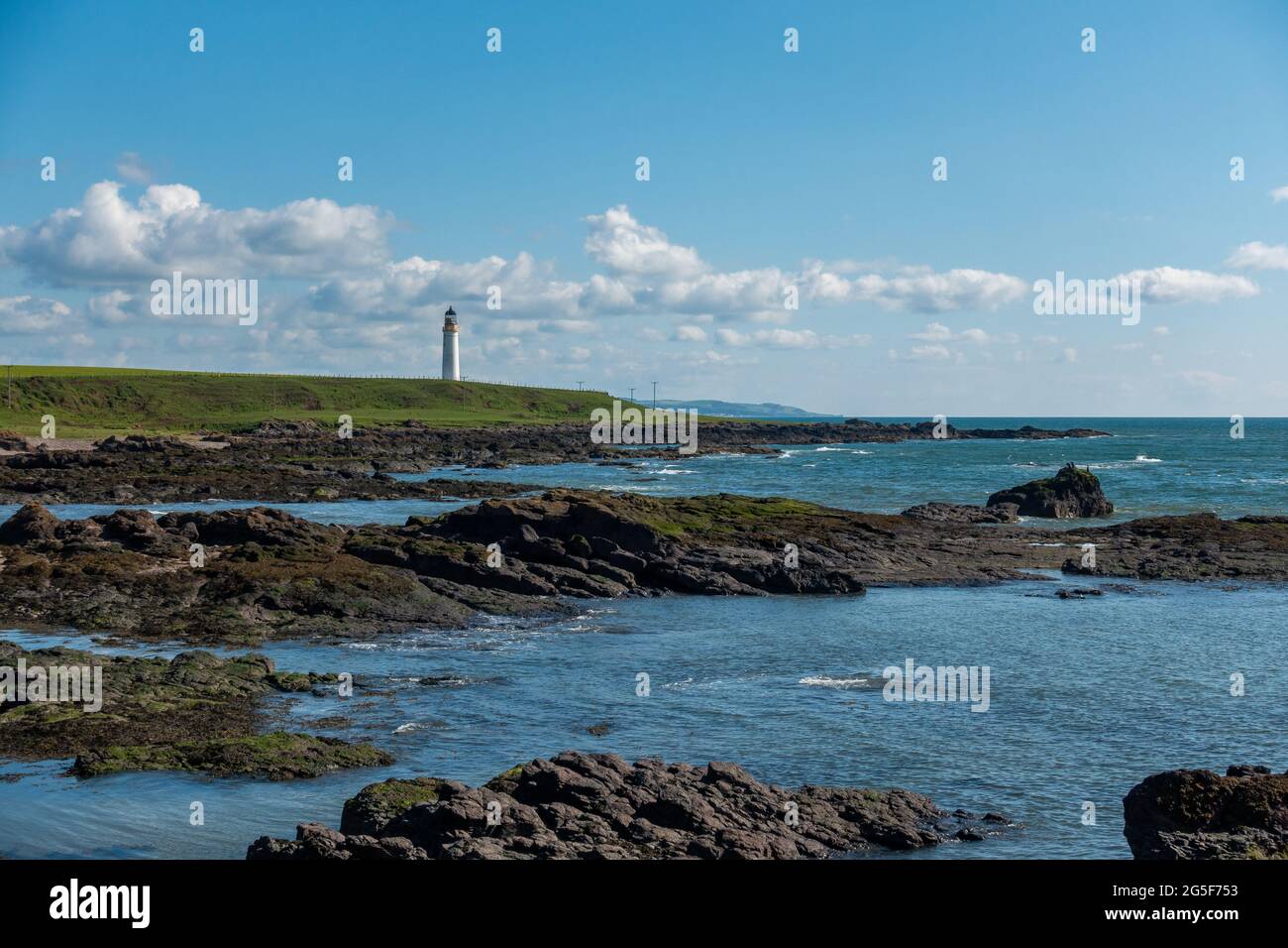 The lighthouse at the rocky headland of Scurdie Ness, Ferryden near Montrose, Scotland Stock Photo