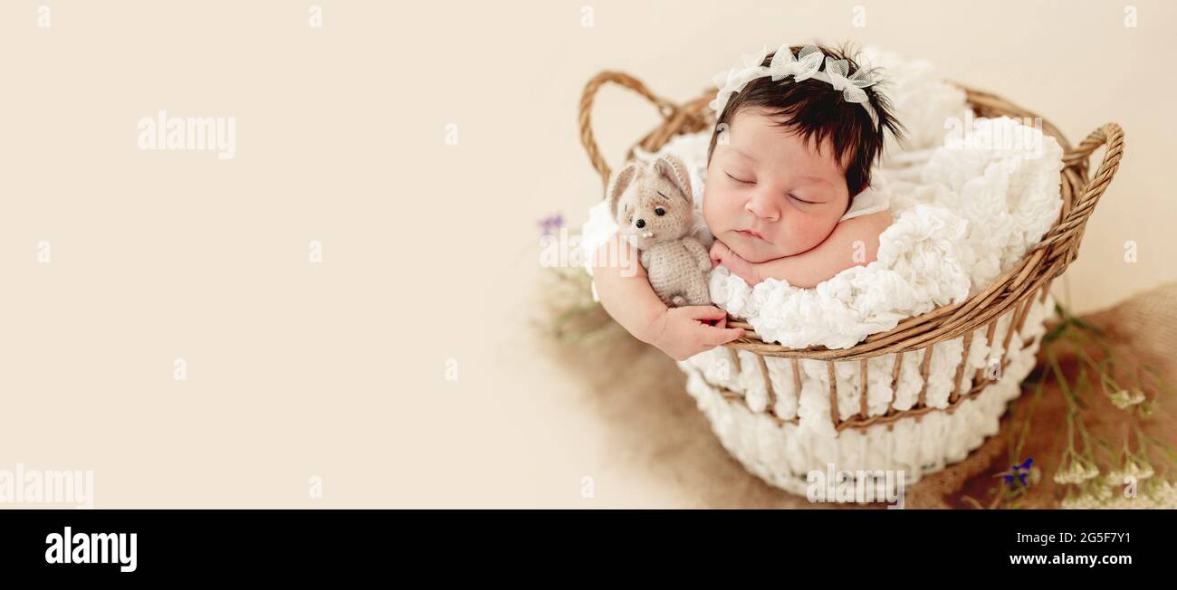 Funny newborn in basket on stomach Stock Photo